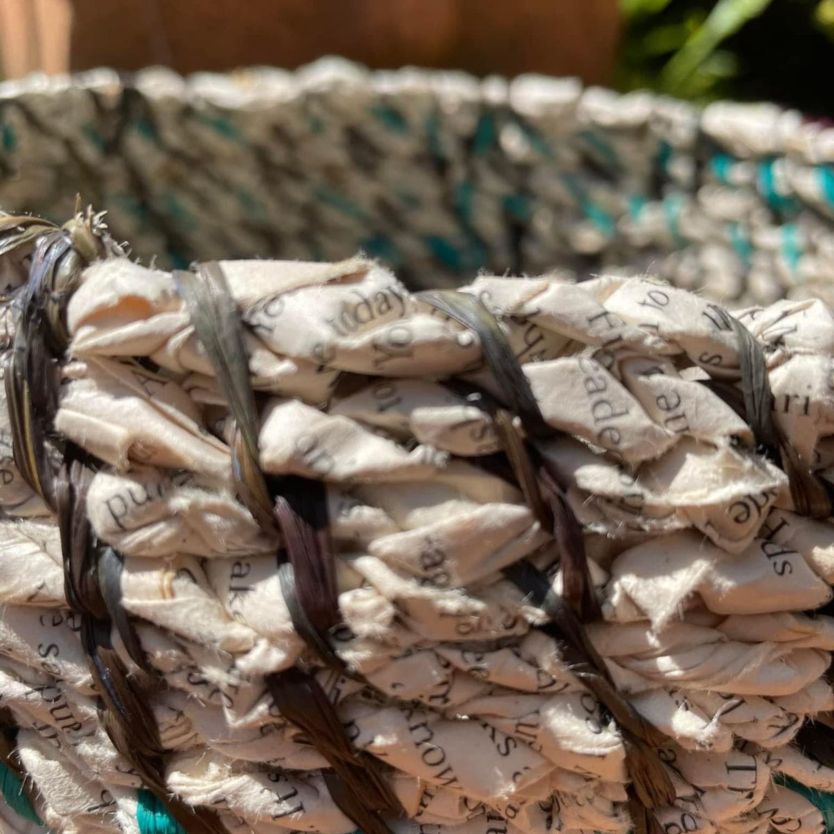 Close detail of a teal and cream coiled rim